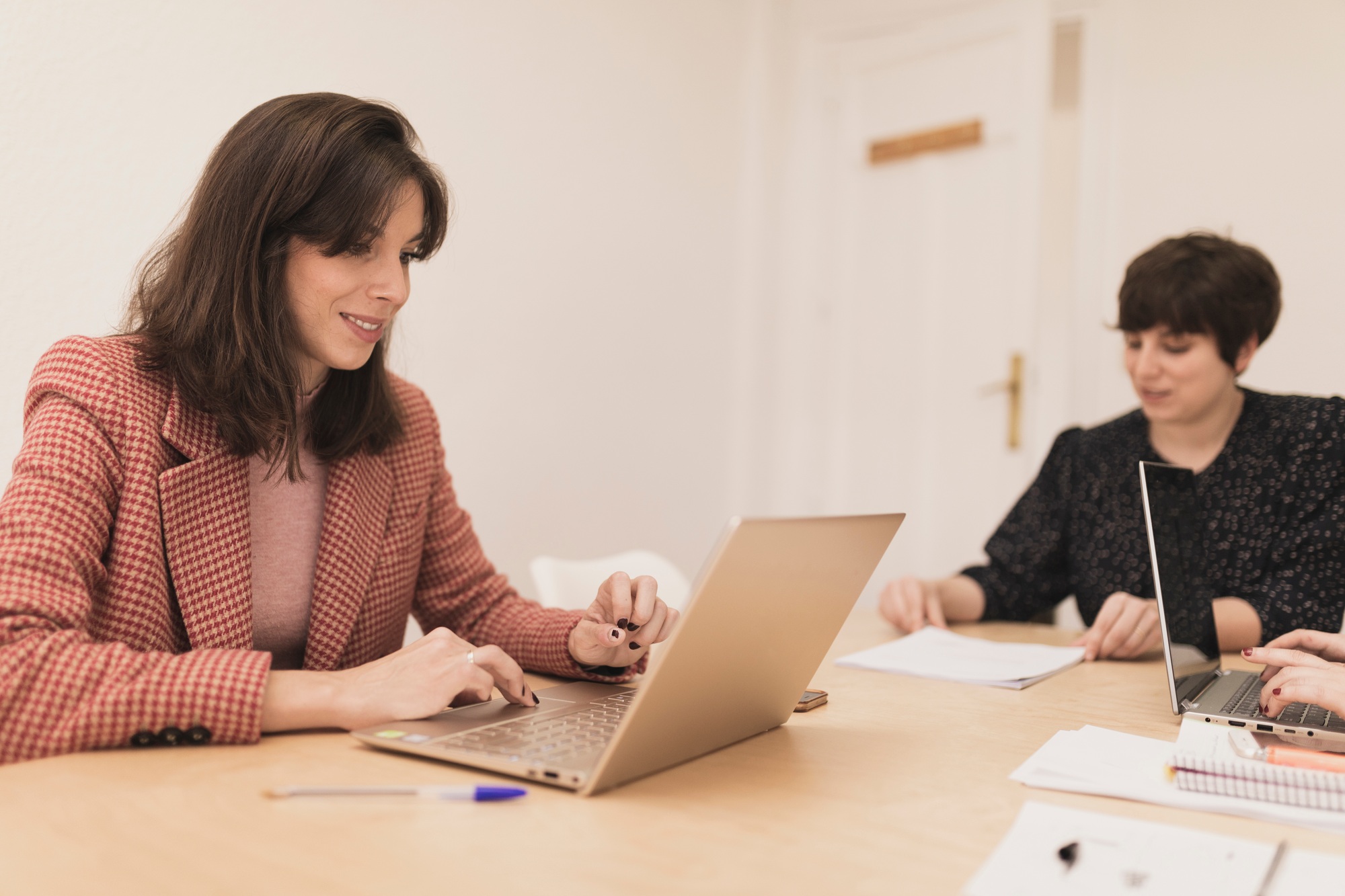 Serious women using laptops at workplace